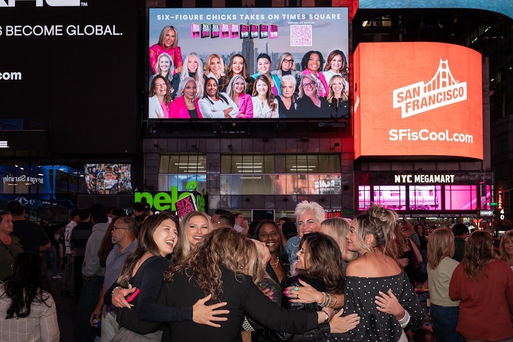 Six-Figure Chicks authors in Times Square at night